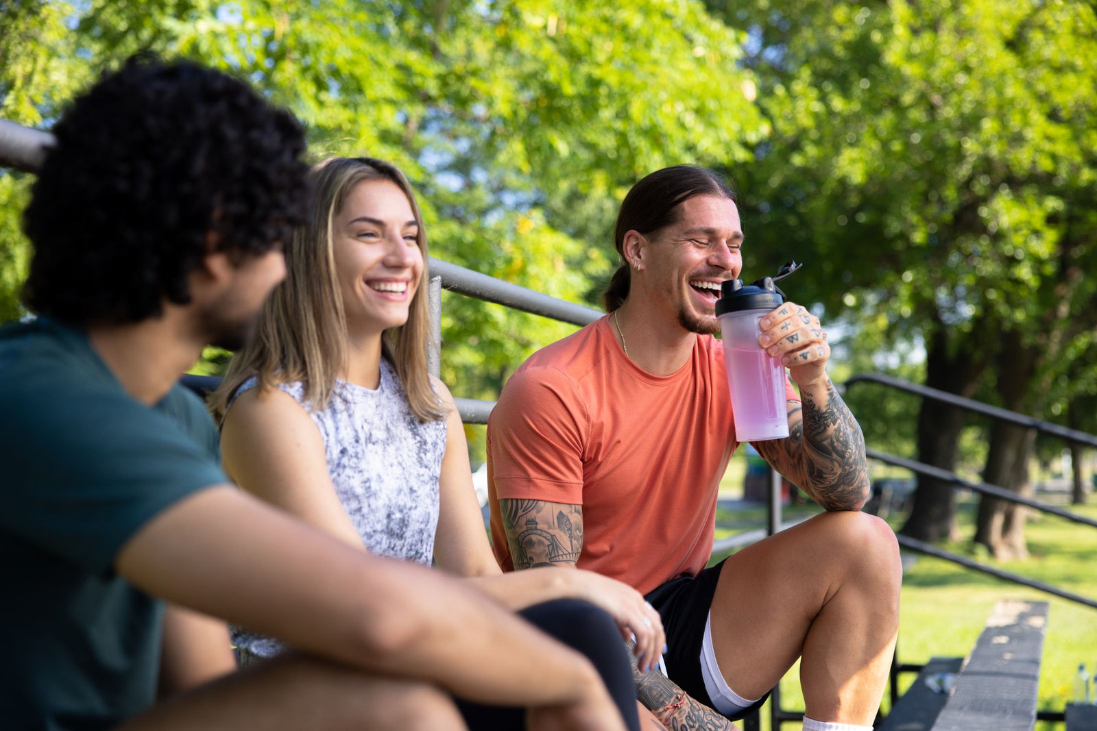 Athlete drinking a protein shake in a park