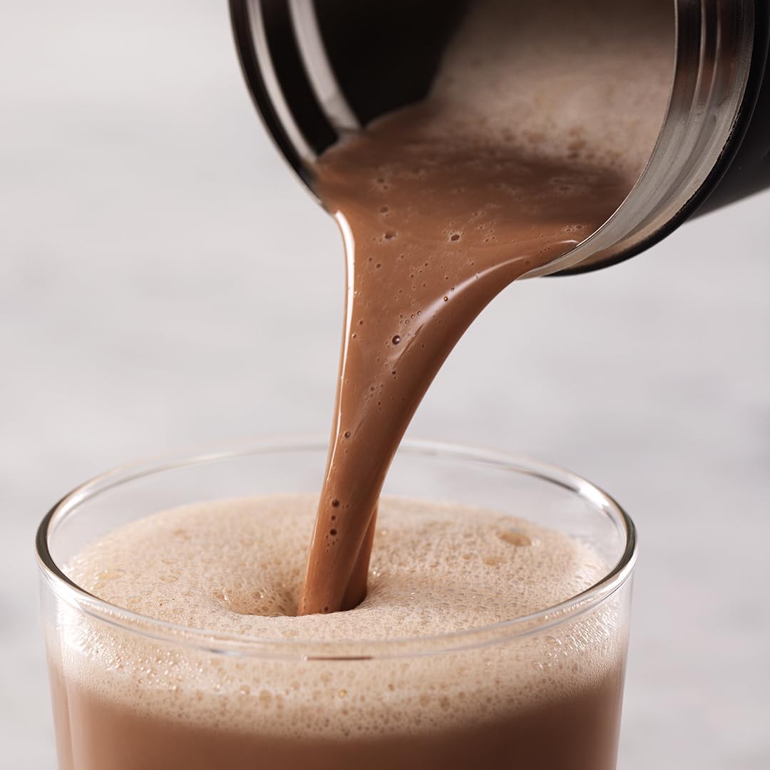 A smooth chocolate protein shake being poured